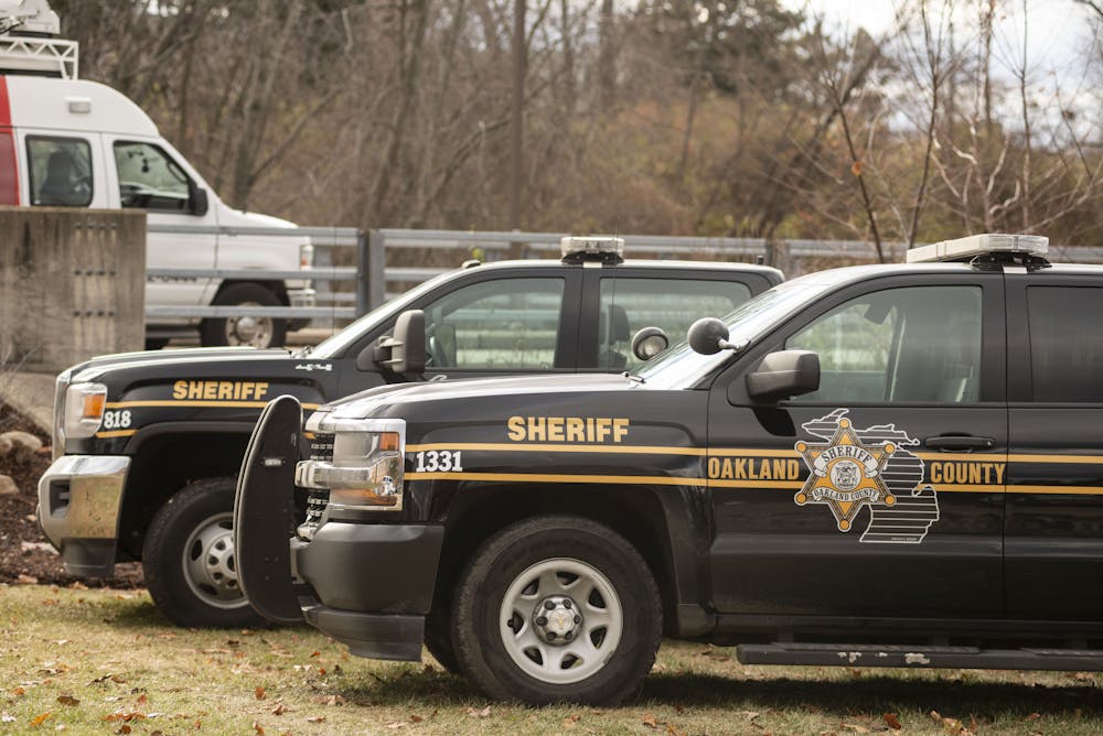 <p>Two Oakland County Sheriff vehicles during the search of the Red Cedar River for the search for Brendan Santo at the Jenison Fieldhouse on December 2, 2021.</p>