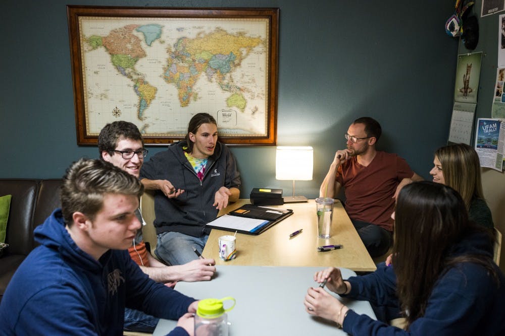 Environmental studies and sustainability junior Taylor Struna, center left, leads a discussion during the MSU Traveler's Club meeting on March 31, 2017 at Olin Health Center. The MSU Traveler's Club is a club that provides a social space and support for people who are in recovery from addiction. 