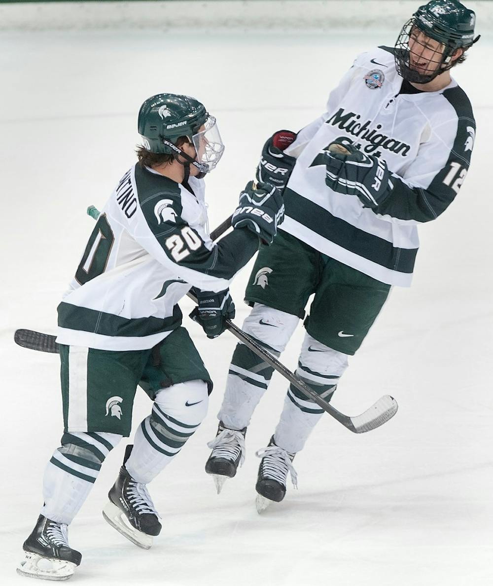 	<p>Freshman forward Ryan Keller, right, congratulates freshman forward Michael Ferrantino, who scored in the third period of the game. The Spartans defeated the Wildcats, 4-2, Saturday, Feb. 16, 2013, at Munn Ice Arena. Justin Wan/The State News</p>