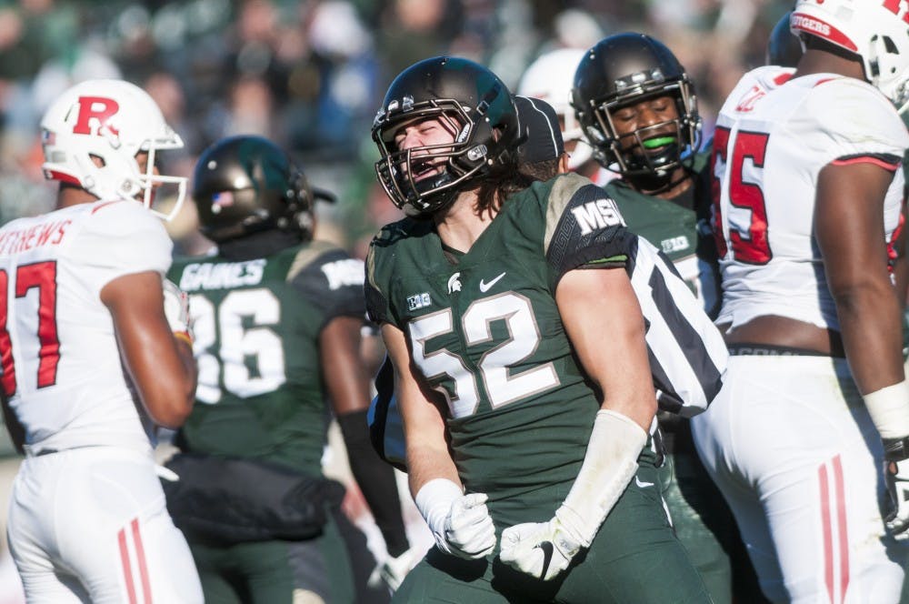 Sophomore defensive end Dillon Alexander (52) celebrates after a play during the game against Rutgers on Nov. 12, 2016 at Spartan Stadium. The Spartans defeated the Scarlet Knights, 49-0.