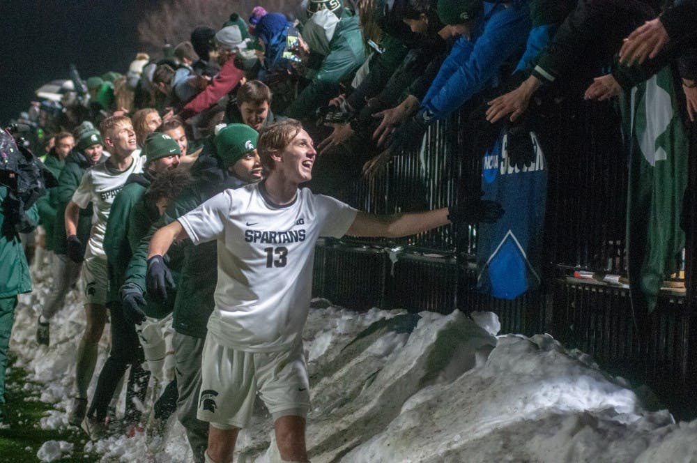 The Spartans high-five fans after the game during the game against James Madison at DeMartin Stadium on Dec. 1, 2018. The Spartans beat the Duke Dogs, 2-1. The Spartans advance to the College Cup for the first time since 1968.