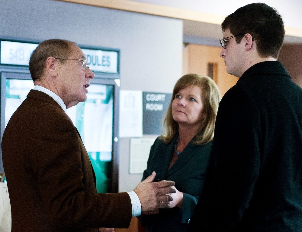 	<p>Advertising junior Brandon Carmack, right, talks with his mother, Barb Carmack and attorney, William Hankins after the second preliminary hearing of the case on Monday, Nov. 26, 2012 at City Hall, 410 Abbot Road.</p>