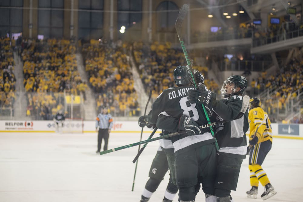 <p>MSU hockey players celebrate after scoring their first goal of the game at the game against Michigan on Nov. 5, 2021, at Yost Ice Arena.</p>
