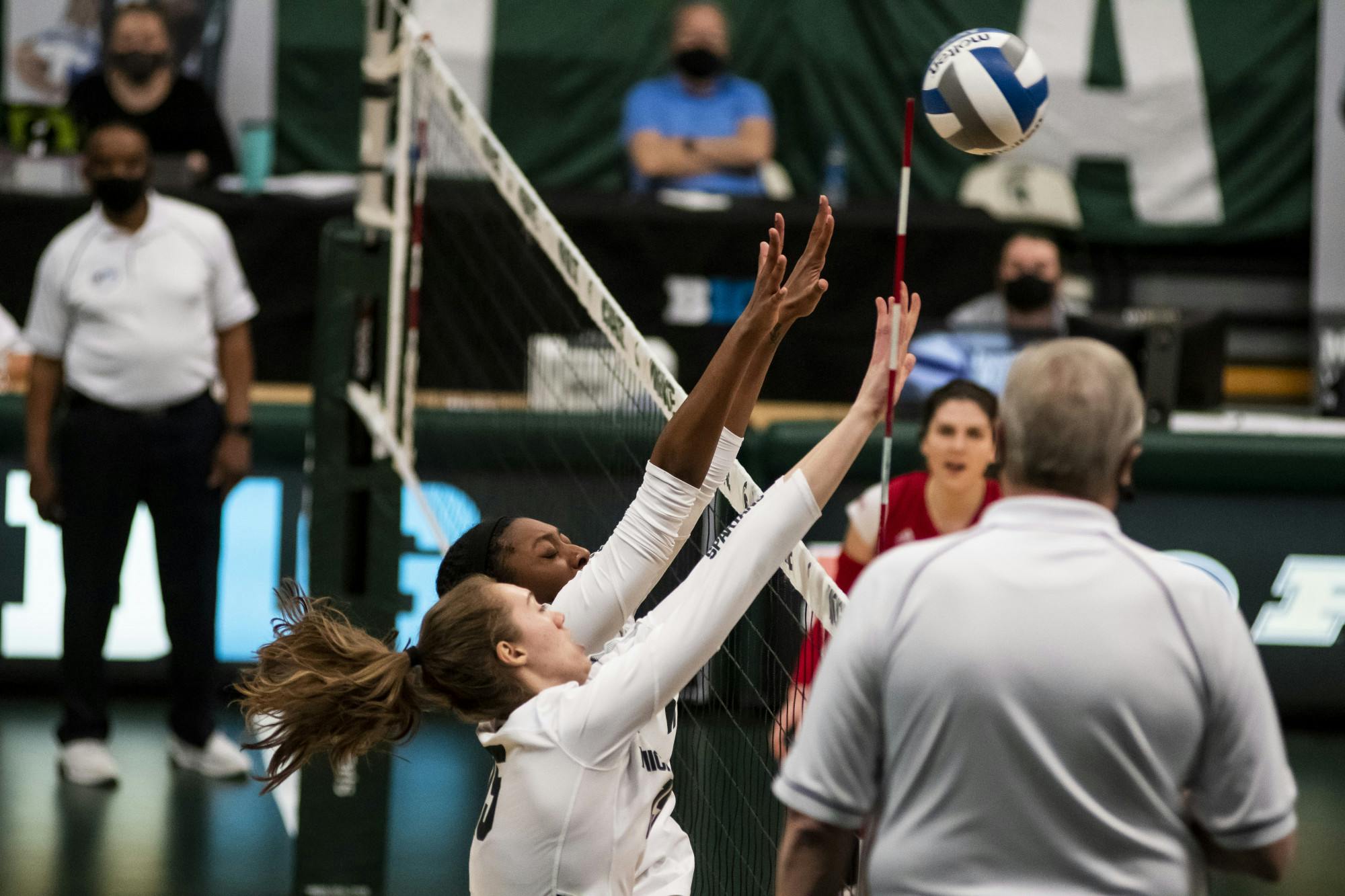 <p>Then-redshirt senior outside hitter Lauren Swartz (15) and junior middle blocker Naya Gros (17) blocking the ball at the net during the game against Rutgers on April 2, 2021, at the Jenison Fieldhouse. The Scarlet Knights defeated the Spartans 3-2.</p>