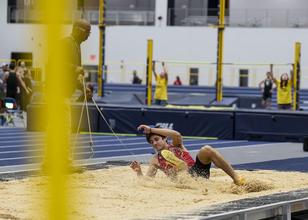 <p>A runner slides into the sand pit at the Silverston Invitational track and field competition held in Ann Arbor, Mich. on Feb. 20, 2026.&nbsp;</p>
