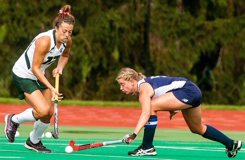 <p>Senior forward Allie Ahern fights for the ball from Maine back/midfielder Nicole Sevey during a game against the University of Maine Aug. 31, 2014, at Ralph Young Field. The Spartans defeated the Black Bears, 5-4 in overtime. Jessalyn Tamez/The State News </p>