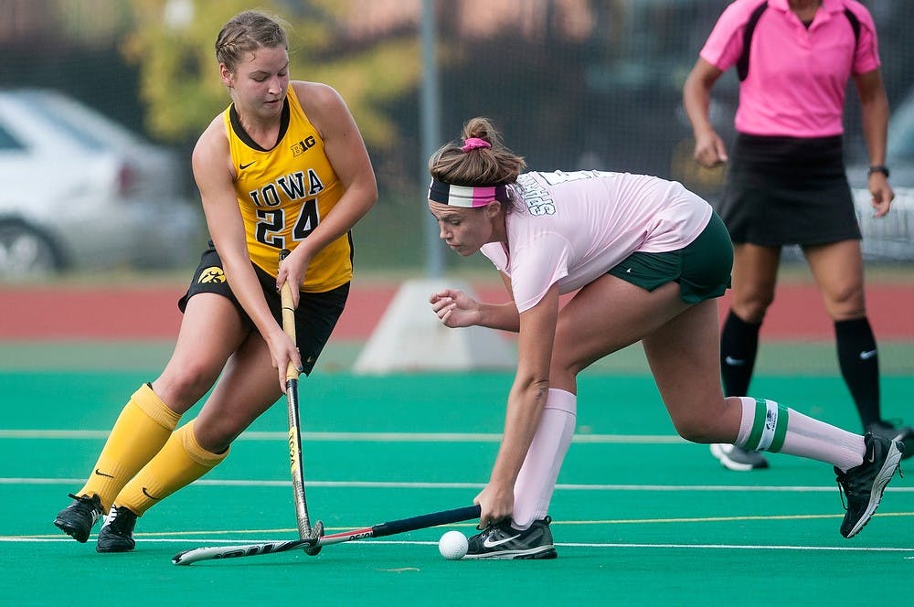 <p>Senior forward Abby Barker fights for the ball against Iowa midfielder Melissa Progar on Oct. 17, 2014, at Ralph Young Field. The Spartans defeated the Hawkeyes, 2-0. Aerika Williams/The State News</p>
