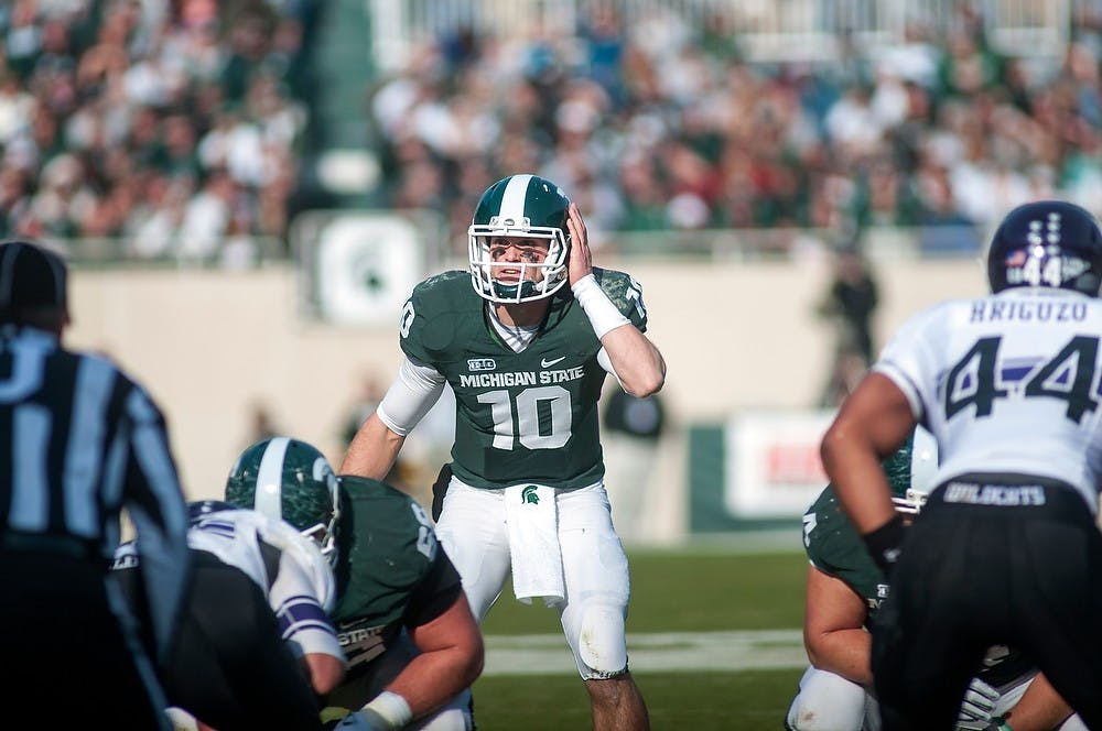 	<p>Junior quarterback Andrew Maxwell attempts to communicate with the offense on Saturday, Nov. 17, 2012, at Spartan Stadium. Maxwell finished the game with 297 passing yards and two passing touchdowns. James Ristau/The State News</p>