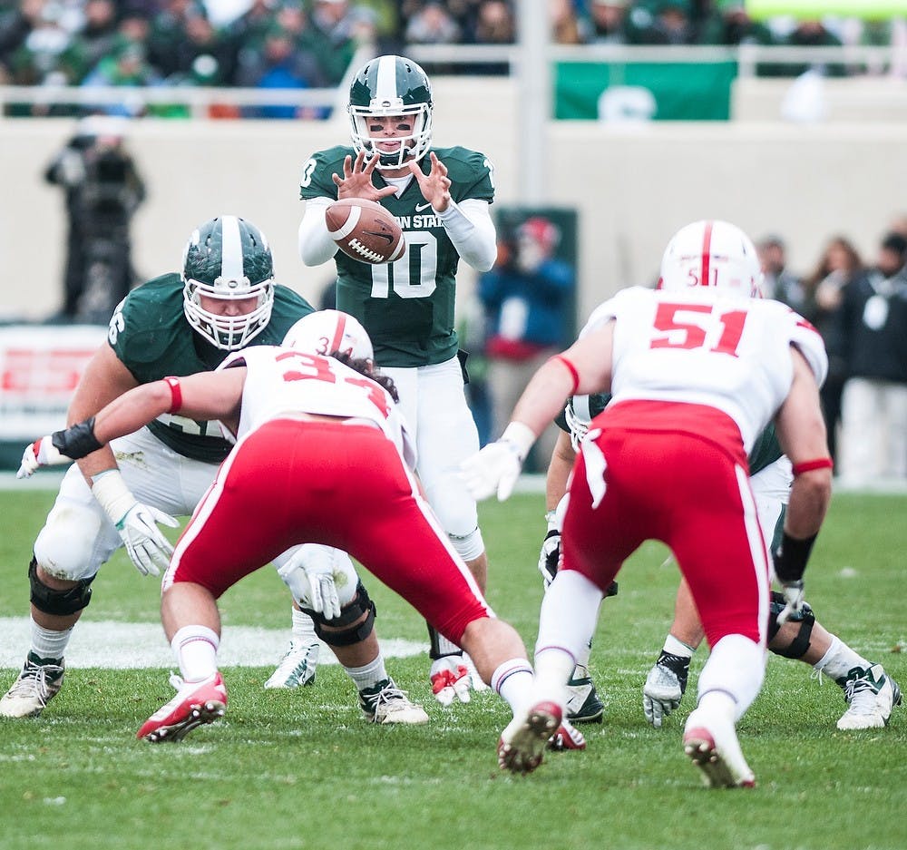 Junior quarterback Andrew Maxwell receives the snap at the game against Nebraska Nov. 3, 2012, at Spartan stadium. The final score was 28-24 with Nebraska taking the win. Katie Stiefel/ State News