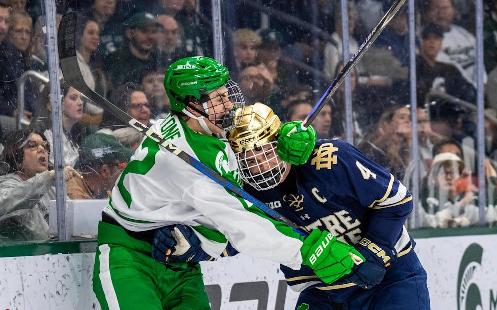 MSU Fr. F, Porter Martone (22), gets into a fight with a Notre Dame player after getting pushed into the wall in Munn Ice Arena in East Lansing, MI on Feb. 19, 2026.