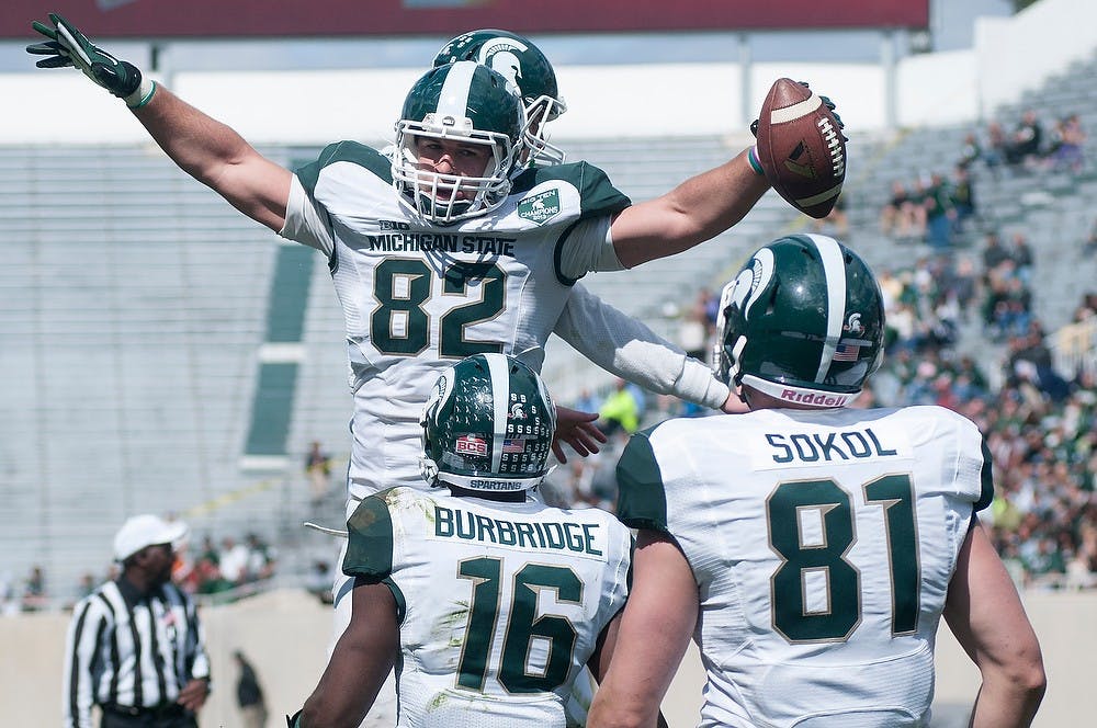 <p>Sophomore tight end Josiah Price celebrates his touchdown with his teammates April 26, 2014, during the Spring Green and White game at Spartan Stadium.The White team won, 20-13. Julia Nagy/The State News</p>