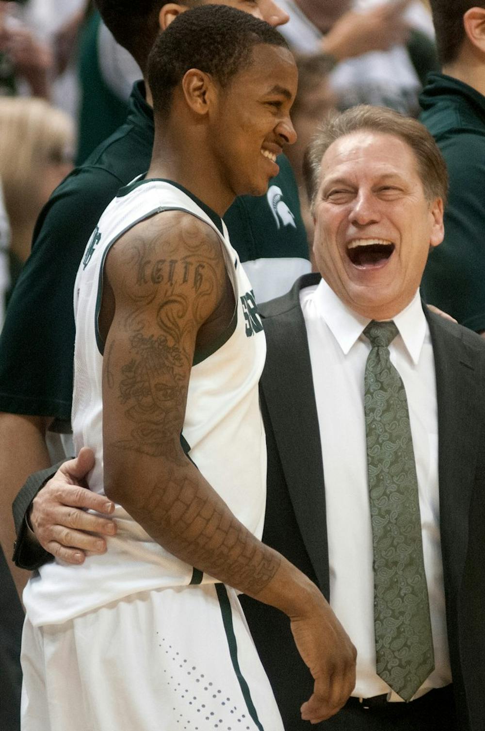<p>Head coach Tom Izzo laughs with former MSU guard Keith Appling at the end of the game against Iowa on March 6, 2014, at Breslin Center. The Spartans defeated the Hawkeyes 86-76. Julia Nagy/The State News</p>