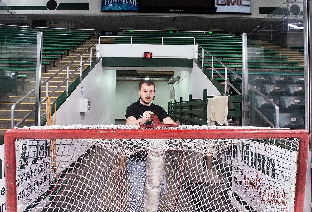 	<p>Ice maintainer and <span class="caps">MSU</span> alumnus Chris Traviglia pulls a hockey net off the ice rink Tuesday, Dec. 4, 2012, at Munn Ice Arena. The ice maintenance team at Munn is responsible for managing the rink daily, from <span class="caps">MSU</span> hockey to open skate for students. Adam Toolin/The State News</p>
