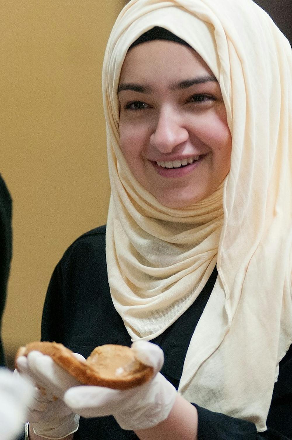 <p>Computer science sophomore Lama Aboubakr prepares peanut butter and jelly sandwiches on Sept. 26, 2014, at the Islamic Society of Greater Lansing, 940 South Harrison Road, in East Lansing. Food was prepared and distributed to the homeless of Lansing. Aerika Williams/ State News</p>