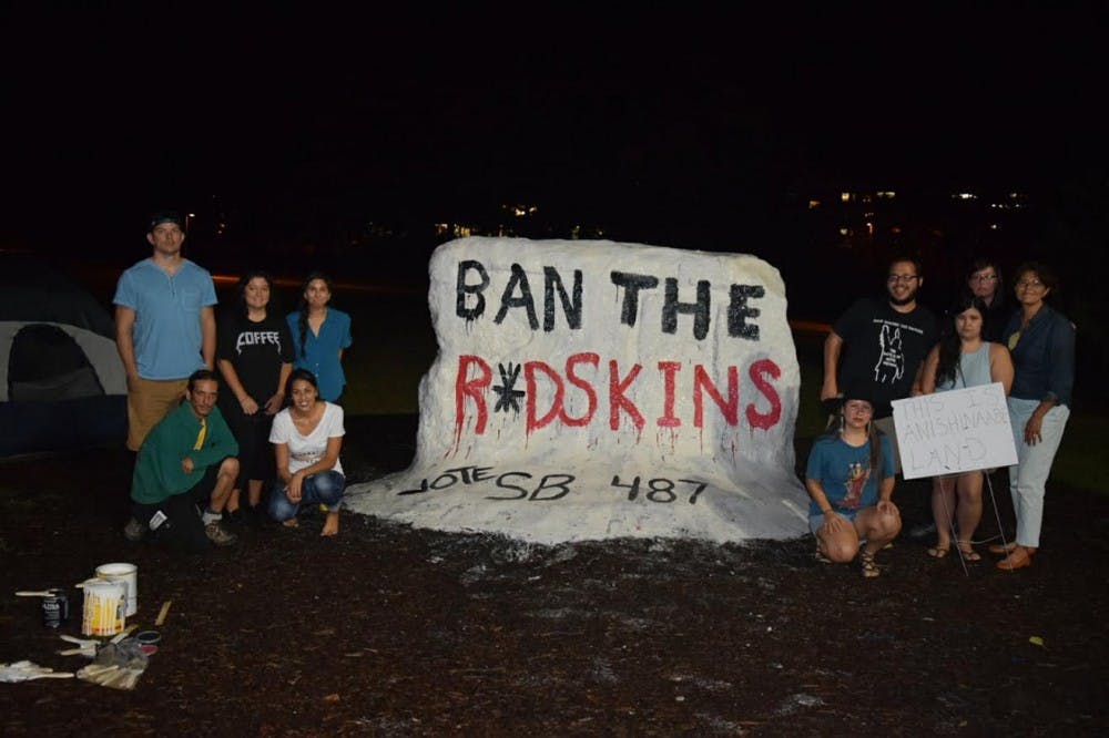 The Native American Law Students Association paints the Rock to educate students on the use of the term "redskin" and Native American imagery in sports. Courtesy of Emmy Scott.