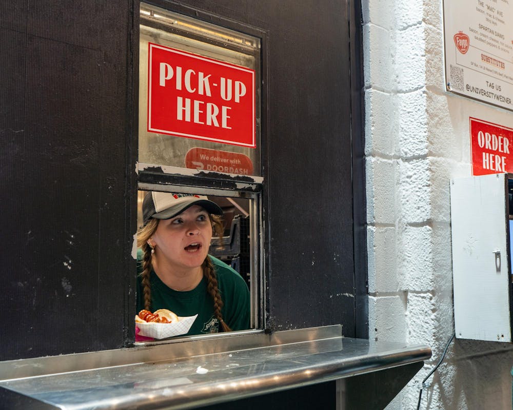 <p>A University Weiner employee calls out an order's name through the pick-up window in East Lansing, MI on April 17, 2026.</p>