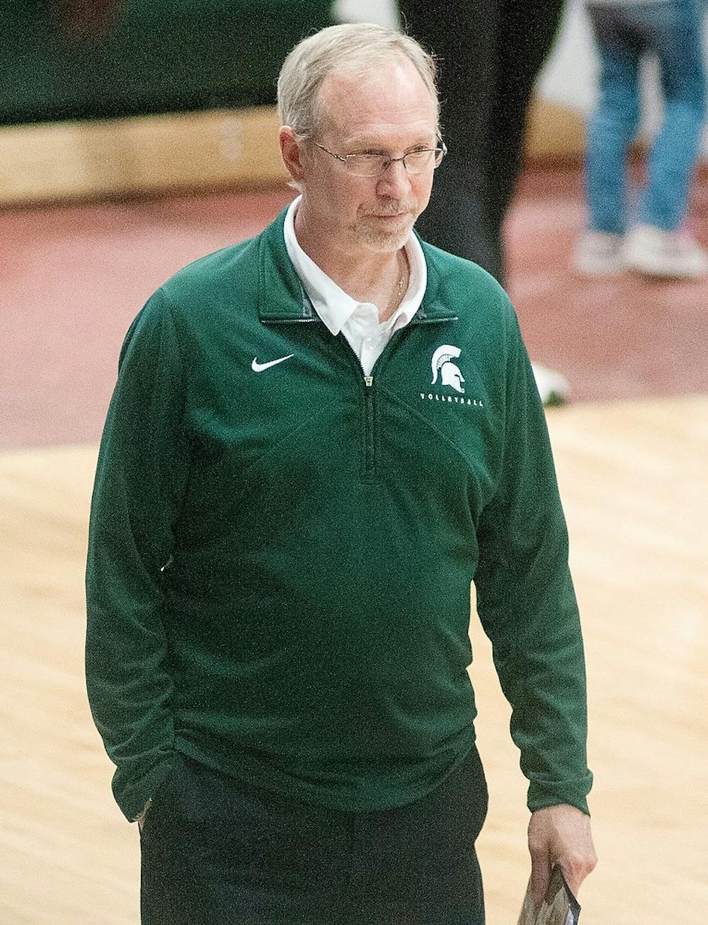 Associate head coach Russ Carney watches the Michigan State University versus Iowa volleyball game from the sidelines of Jenison Field House on Friday, Nov. 2, 2012. MSU won the game in three straight sets. Danyelle Morrow/The State News