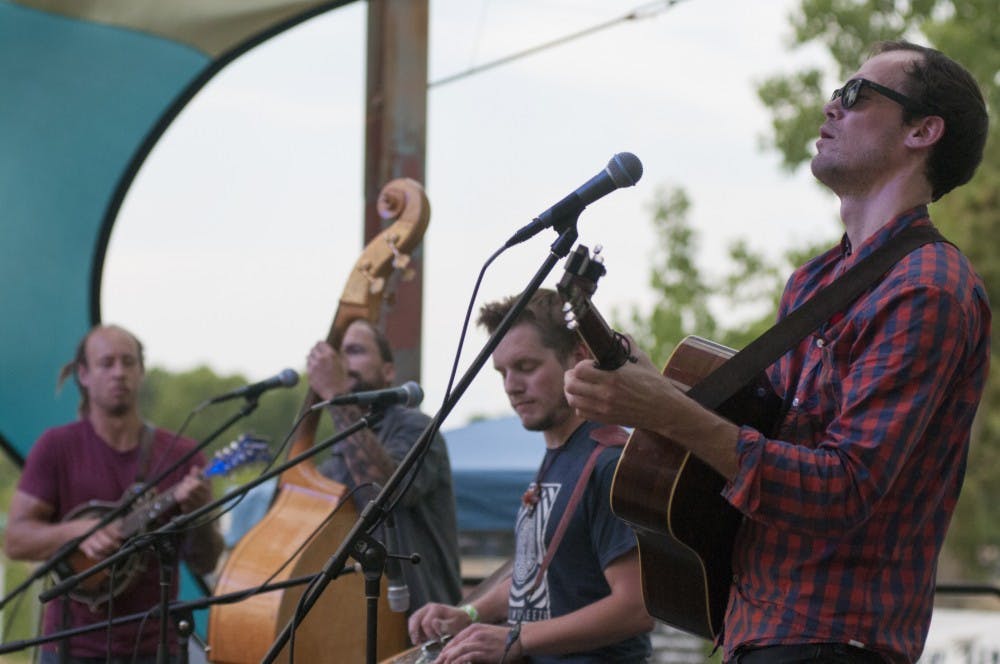 Adam Balcer of Fauxgrass plays guitar during Common Ground Music Festival on July 7, 2016 at Adado Riverfront Park in Lansing, Mich.