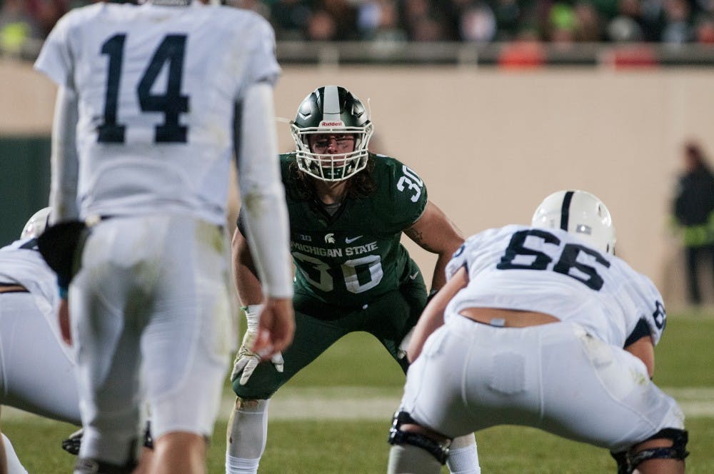 Junior linebacker Riley Bullough looks at Penn State quarterback Christian Hackenberg prior to the snap during the fourth quarter of the game against Penn State on Nov. 28, 2015 at Spartan Stadium. The Spartans defeated the Nittany Lions, 55-16.