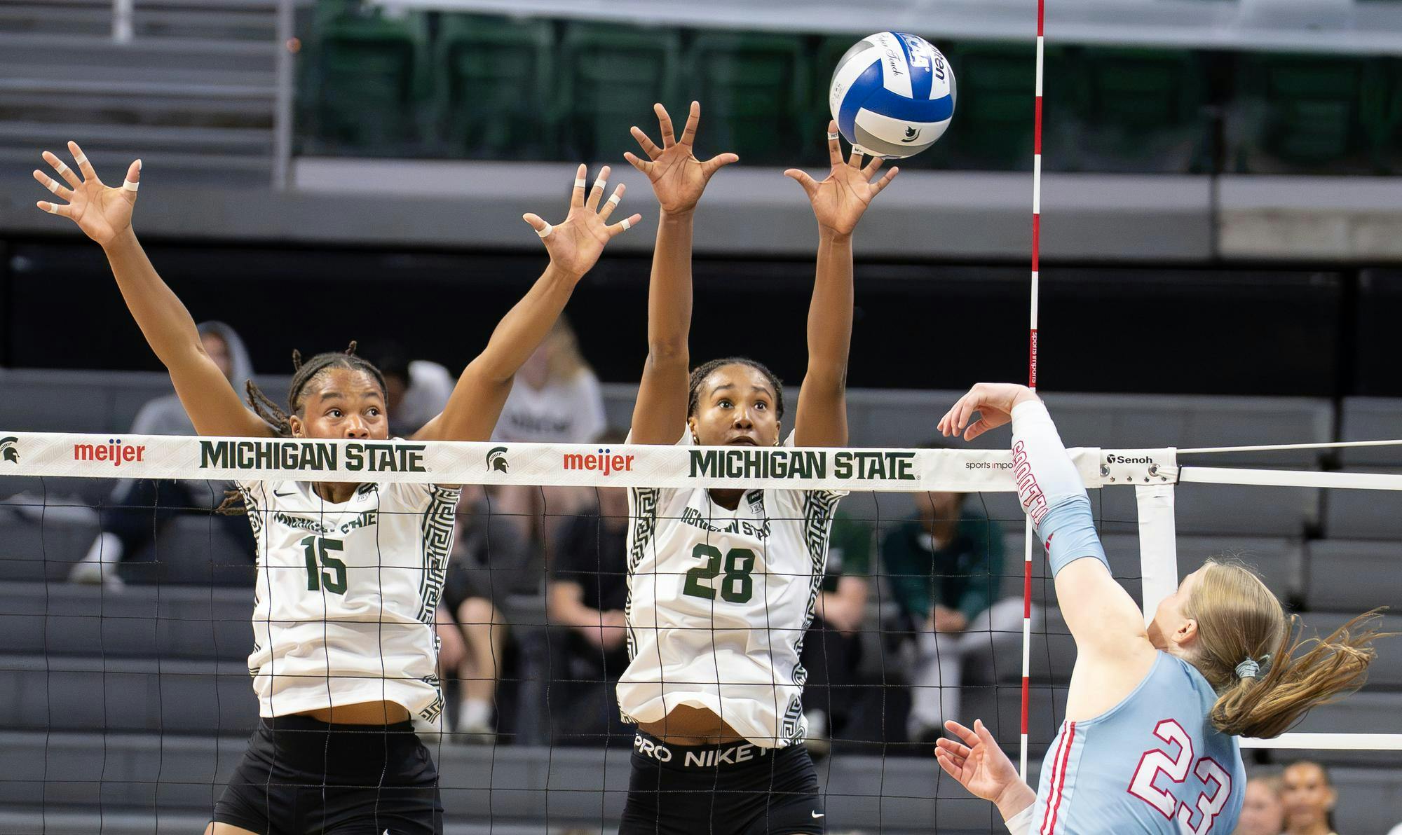 <p>Michigan State senior middle blocker, Zora Hardison (15) and Michigan State senior outside hitter, Alanna Bankston (28) look to the ball as they attempt to block a spike from Drake University outside hitter, Kamryn Behrns (23) in the Breslin Center in East Lansing, Mich., on Friday, Sept. 18, 2026.</p>