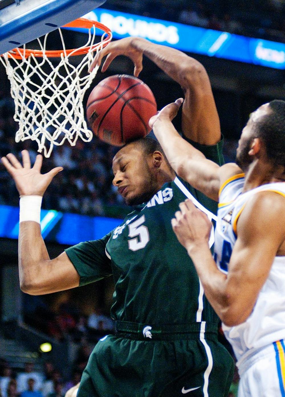Freshman center Adreian Payne gets the ball knocked away by UCLA guard Malcolm Lee. The Spartans are down, 42-24, against the Bruins at the half in the second round of the 2011 NCAA Division 1 Men's Basketball Championship on Thursday night at St. Pete Times Forum in Tampa, Fla. Josh Radtke/The State News