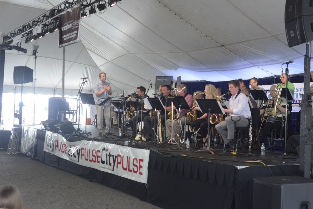 <p>The Lansing Symphony Orchestra performs during the East Lansing Summer Solstice Jazz Festival near Ann Street Plaza June 19th. 2015. Wyatt Giangrande/The State News</p>