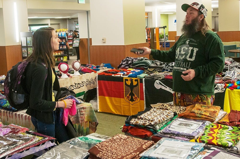 	<p>Bowling Green, Ohio, Tie Dye Thom discusses television shows with customer, kinesiology sophomore Alyssa Thornton in the Union on Feb 11, 2014. Tie Dye Thom&#8217;s &#8220;Enchanted Planets Sale&#8221; was set up by <span class="caps">UAB</span> and continues until Feb. 22, 2014. Casey Hull/The State News</p>