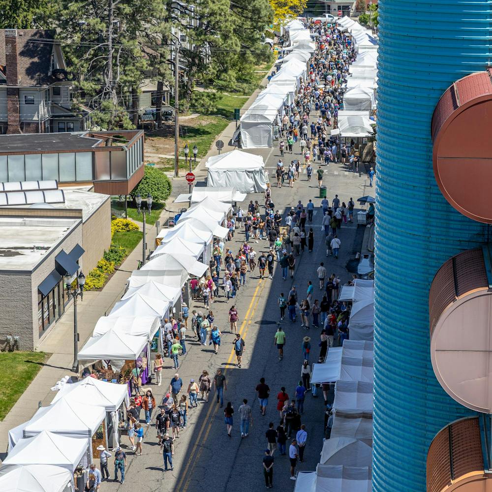 <p>Thousands of attendees walk on Albert Ave during the 63rd annual East Lansing Art Festival in East Lansing, Mich., on May 16, 2026.</p>