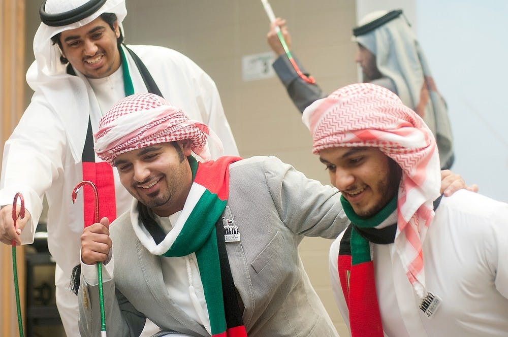 	<p>Finance freshman Khaled Alsheryani, left, mechanical engineering junior Abdul Bafaraj, center, and English Language Center student Manea Al Hammadi, right, participate in Yoolah, a traditional dance of the United Arab Emirates, on Friday, Nov. 30, in the Erickson Hall Kiva. Students gathered to celebrate the 41st National Day by wearing traditional garments, sharing poetry and dancing. Danyelle Morrow/The State News</p>