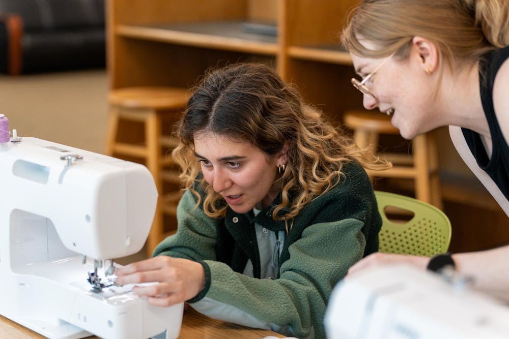 Makerspace Coordinator Jamie Moriarty helps an MSU community member thread a needle during a sewing class in the Makerspace at the MSU Library on April 8, 2026.