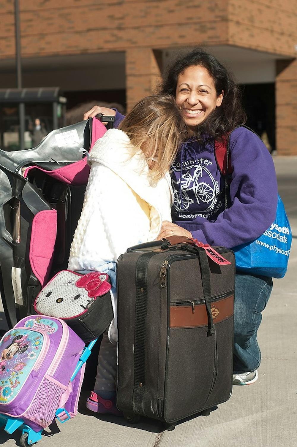 <p>Lansing residents Shannon Branstner and her daughter Isla, 4, arrive in East Lansing March 24, 2015, on the corner of M.A.C. Ave. The two traveled to Texas for ten days to help Branstner's elderly parents move. Kennedy Thatch/The State News</p>