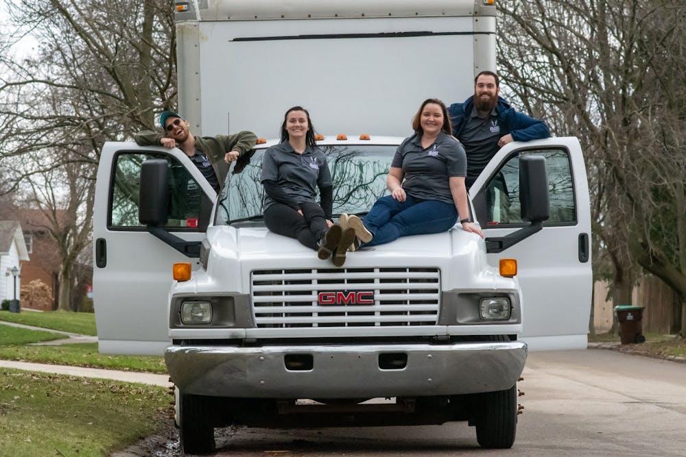 <p>Thomas Horton, Jacquelynn Biggs, Dr. Brittany Giles-Horton, and Colin DeGarmo pose on their moving truck Gertrude on April 7, 2022. </p>