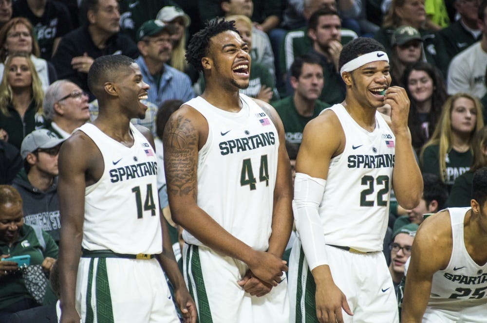 From left to right, senior guard Eron Harris (14), freshman forward Nick Ward (44) and freshman guard Miles Bridges (22) share a moment during the second half of the men's basketball game against Rutgers on Jan. 4, 2017 at Breslin Center. The Spartans defeated the Scarlet Knights, 93-65.