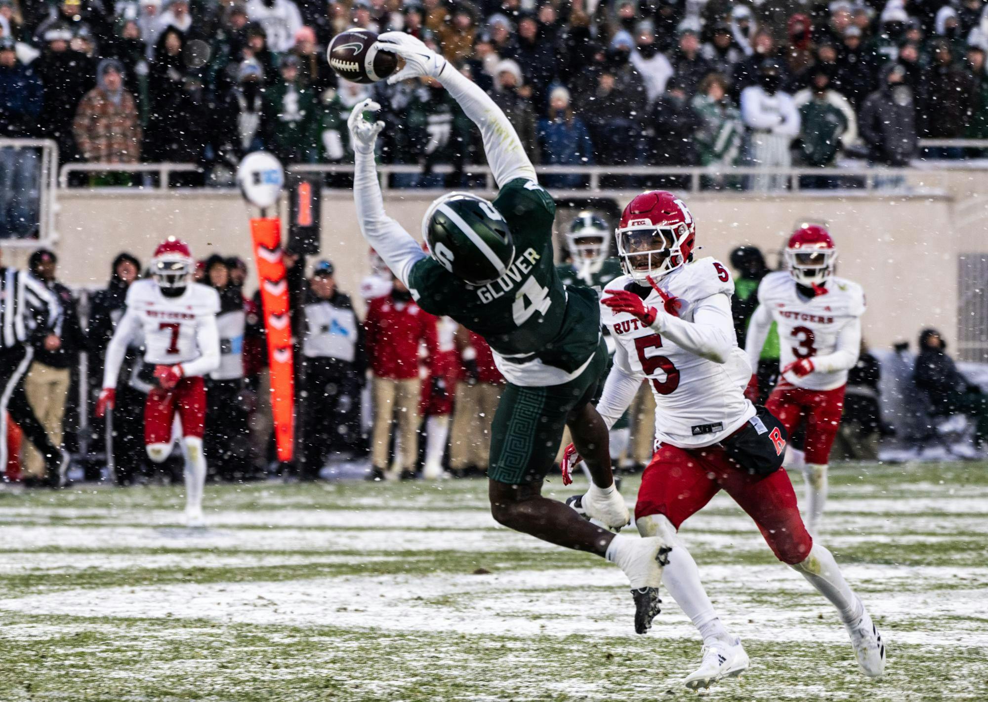 <p>MSU redshirt sophomore wide receiver Jaron Glover (4) tries to catch the kick despite the defense by Rutgers Scarlet Knights senior running back Kyle Monangai (5) at Spartan Stadium on Nov. 30, 2024.</p>