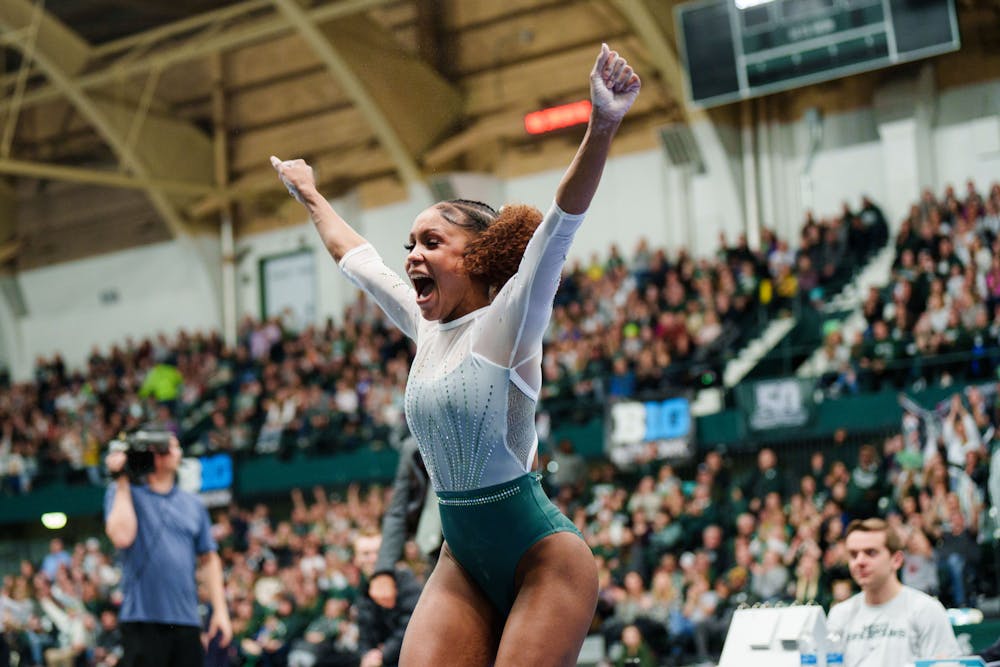<p>Freshman Nikki Smith celebrates after her vault during a meet against University of Michigan, held at Jenison Field House on Jan. 22, 2023. The Spartans upset the No. 3 ranked Wolverines with 197.200 points.</p>