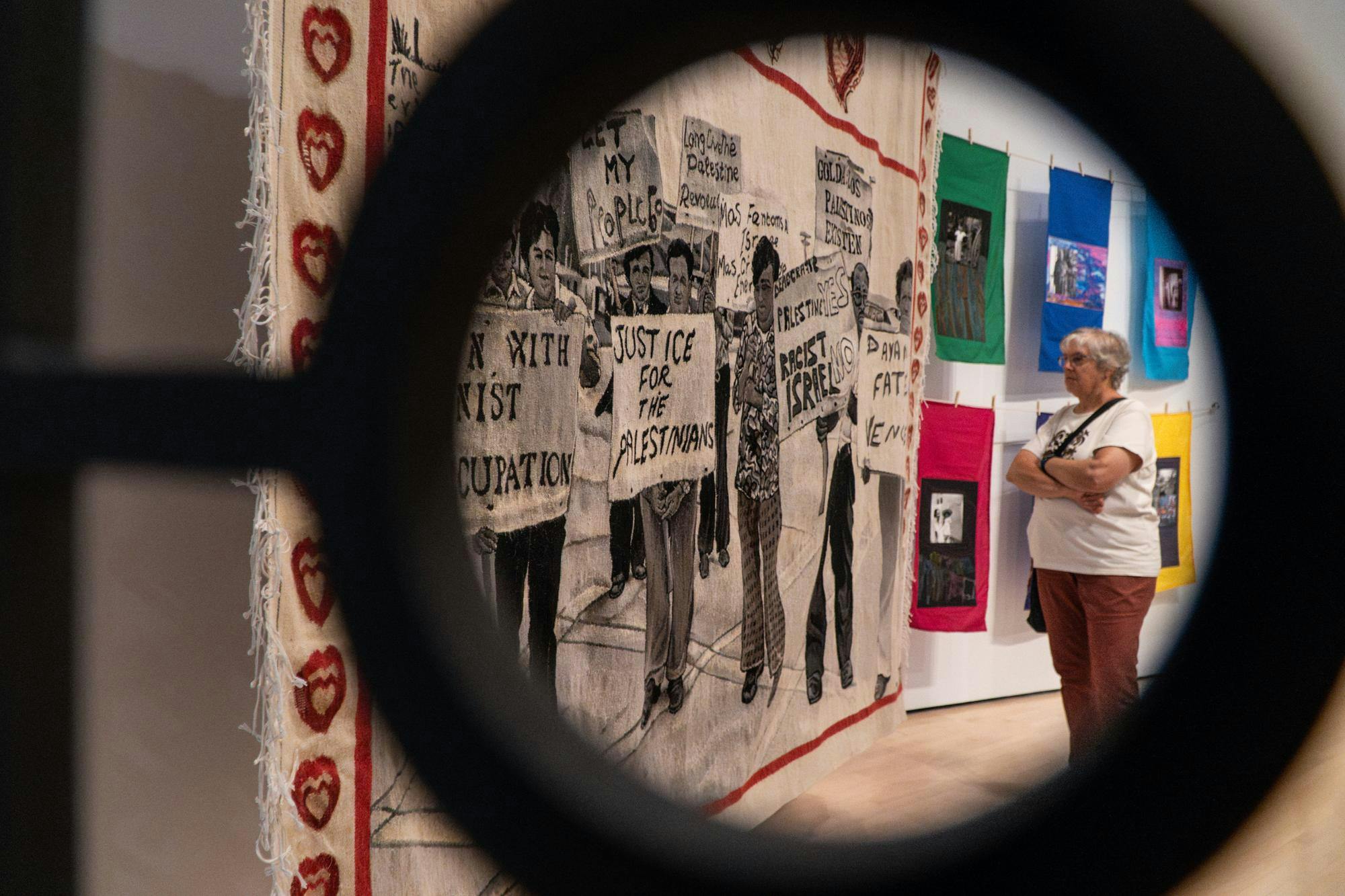 A visitor observes a tapestry art piece inside of the “Diasporic Collage” exhibition at the Broad Art Museum on Sept. 19, 2024. A content warning reagarding this piece was put outside of the exhibition. 