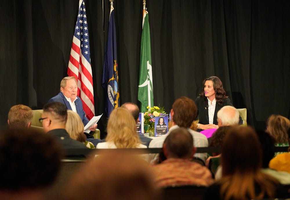 Gov. Gretchen Whitmer speaks with former Gov. James Blanchard during the MSU stop on her book tour on July 23, 2024.