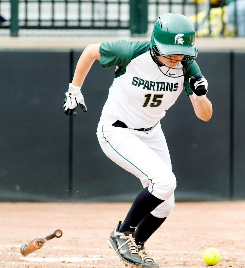 Freshman first baseman McKinzie Freimuth bunts the ball but failed to get to the first base in time. The Wolverines defeated the Spartans by 8-0 Saturday afternoon at Secchia Stadium at Old College Field. Justin Wan/The State News