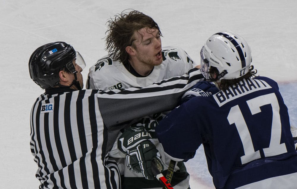 <p>Junior center Tommy Apap (11) starts a fight in the second period with Penn State&#x27;s center Evan Barratt. Michigan State fell to Penn State 2-1 on Jan. 25, 2020.</p>