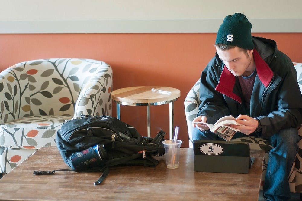 <p>Political theory and constitutional democracy sophomore Jaaz Catterall works on homework Jan. 26, 2015, in the newly renovated Bubble Island, 515 E. Grand River Ave. in East Lansing. Catterall said he likes the new comfortable chairs and spacious layout. Kelsey Feldpausch/The State News.</p>