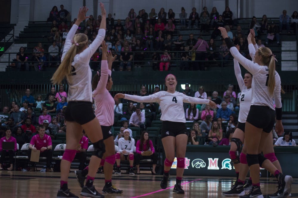 The Spartans celebrate after scoring a point during the game against Rutgers on Oct. 19, 2016 at Jenison Fieldhouse The Spartans defeated the Scarlet Knights, 2-1.