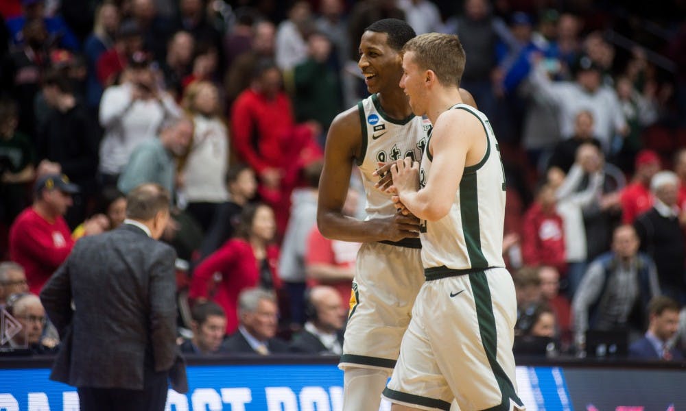 <p>Junior forwards Marcus Bingham Jr. (30) and Thomas Kithier (15) celebrate their win after the NCAA tournament game against Bradley at Wells Fargo Arena on March 21, 2019. The Spartans defeated the Braves, 76-65.</p>