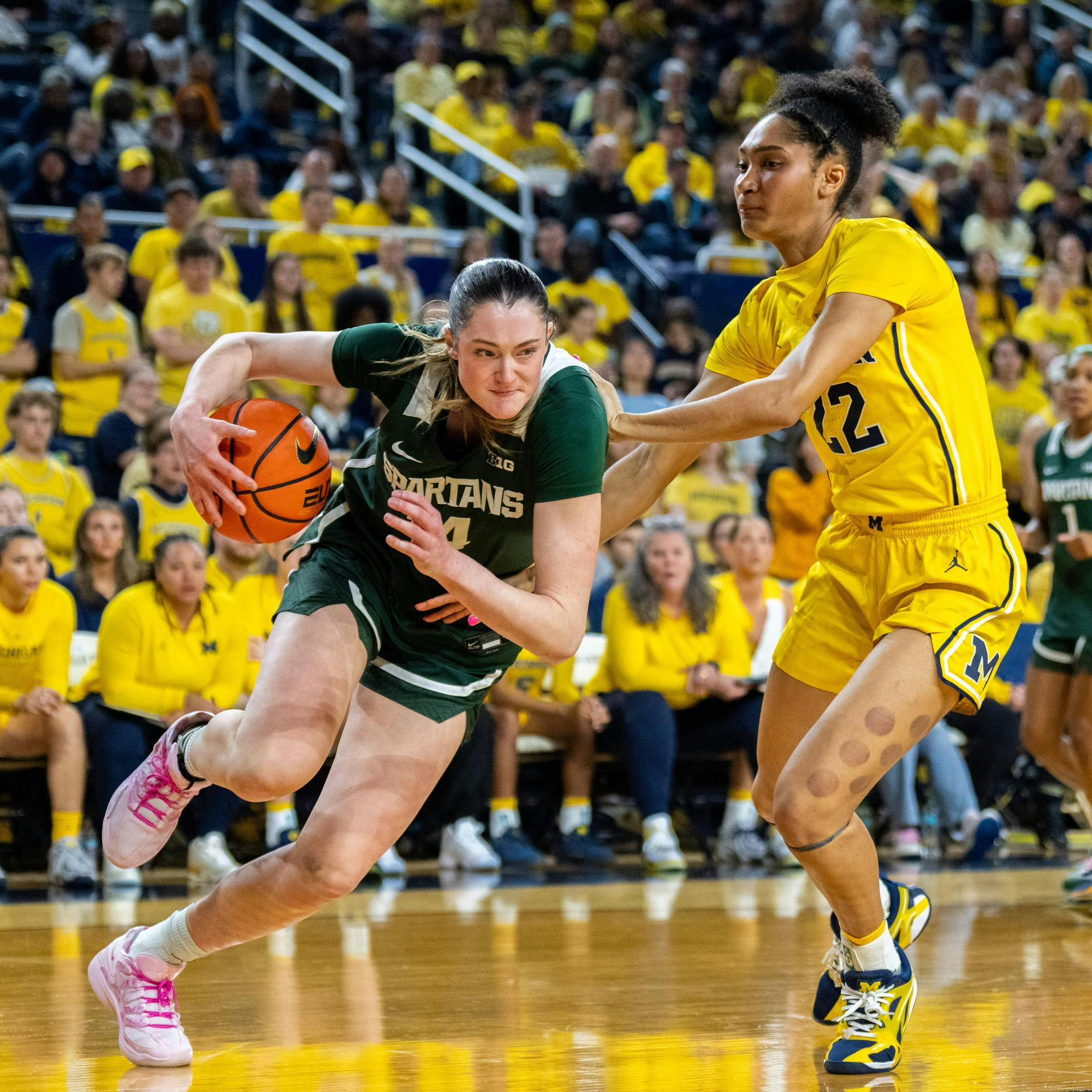 <p>MSU Sr. F, Grace VanSlooten (14), pushes against a Michigan defender in the Crisler Center in Ann Arbor, MI on Feb. 15, 2026.</p>