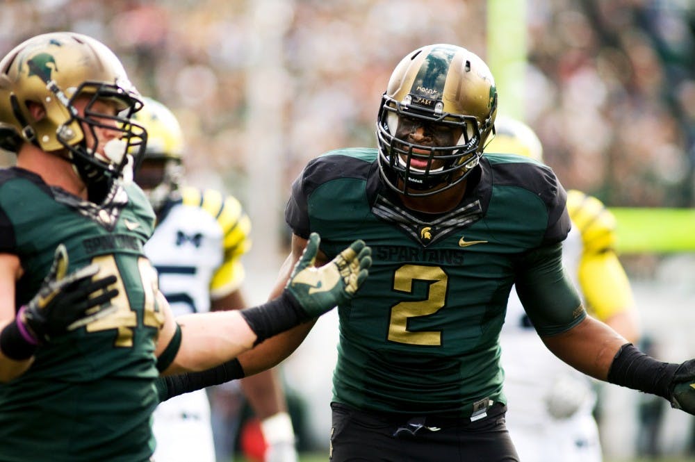 Sophomore defensive end William Gholston, right, and red-shirt freshman defensive end Marcus Rush throw their hands up to the referee after a roughing the passer call was made on Rush during Saturday's game against Michigan at Spartan Stadium. Lauren Wood/The State News