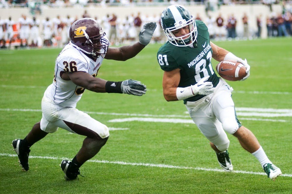 Senior wide receiver Brad Sonntag nears the end zone past Central Michigan defensive back Avery Cunningham during the second half of Saturday's game at Spartan Stadium. Lauren Wood/The State News