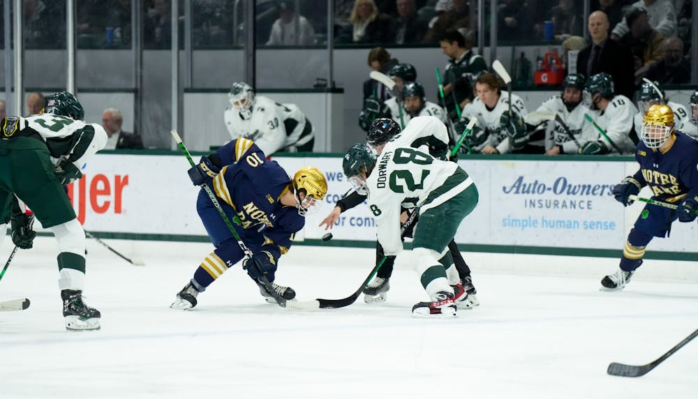 <p>Notre Dame's sophomore forward (10) faces off with Michigan State's freshman forward Karsen Dorwart (28) during a game at Munn Ice Arena on Feb. 3, 2023. The Spartans defeated the Fighting Irish 3-0.</p>