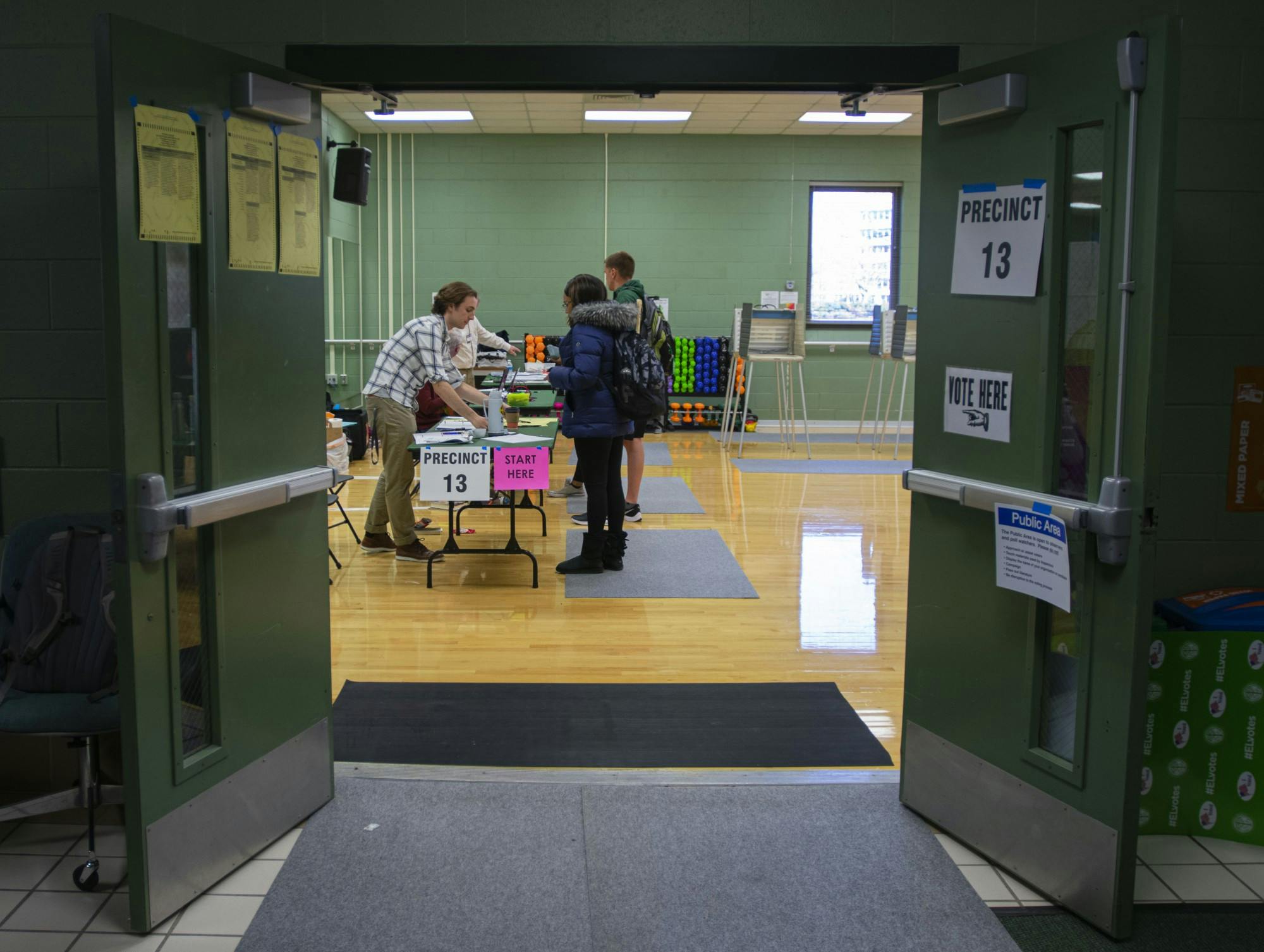 <p>Volunteers help students during their voting process at the District 13 polling precinct in IM Sports East. The Michigan primary took place March 10, 2020.</p>