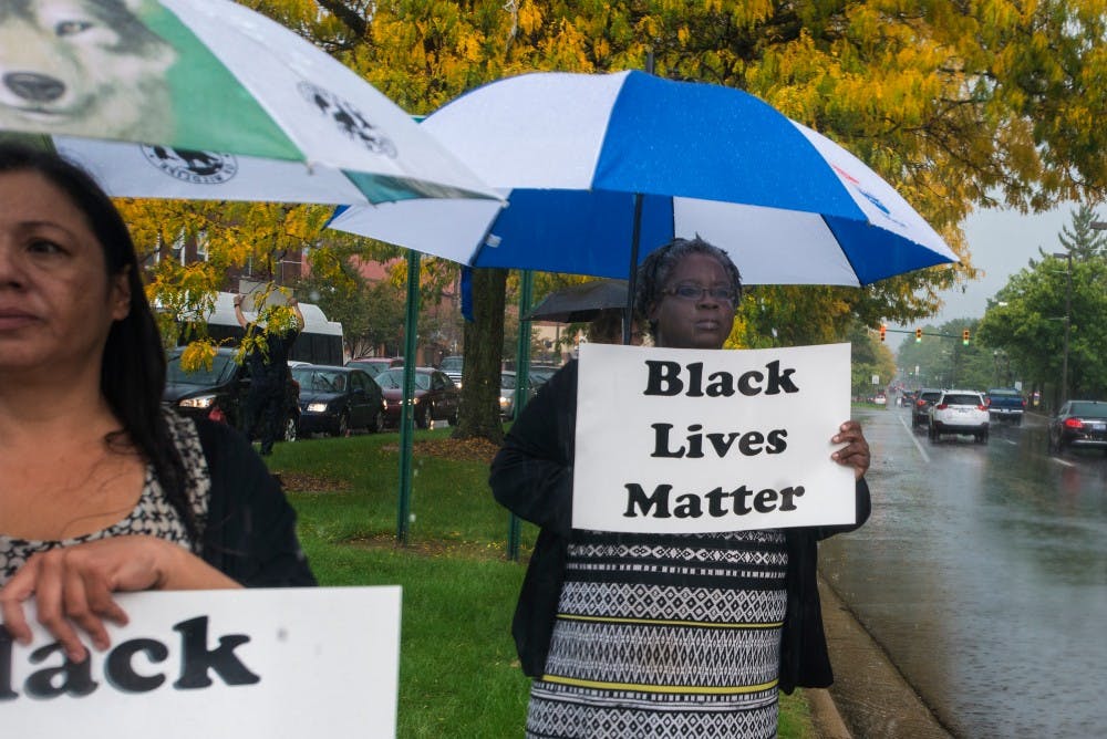 People protest for lost Black lives on Oct. 7, 2016 at the median on Grand River Ave. The group honored those who have been killed, recited poetry and shared personal testimonials. 
