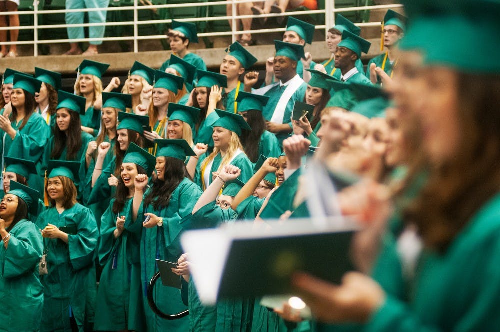 	<p>Students of the graduating class of 2013 sing the fight song during the convocation ceremony May 3, 2013, at Breslin Center. Graduating seniors were honored during the ceremony with a motivational speech presented by Emmy award-winning actor Timothy Busfield. Danyelle Morrow/The State News</p>