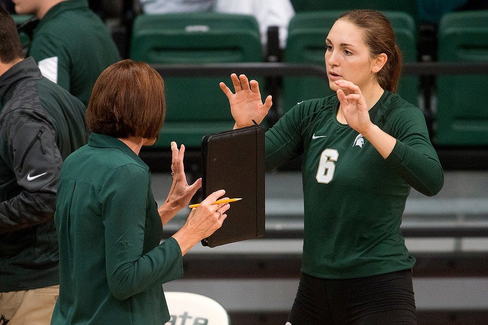 <p>Head coach Cathy George talks to then sophomore middle blocker/opposite Allyssah Fitterer during a timeout during a game against LIU Brooklyn on Sept. 19, 2014, at Jenison Field House. The Spartans lost, 3-2. Julia Nagy/The State News</p>